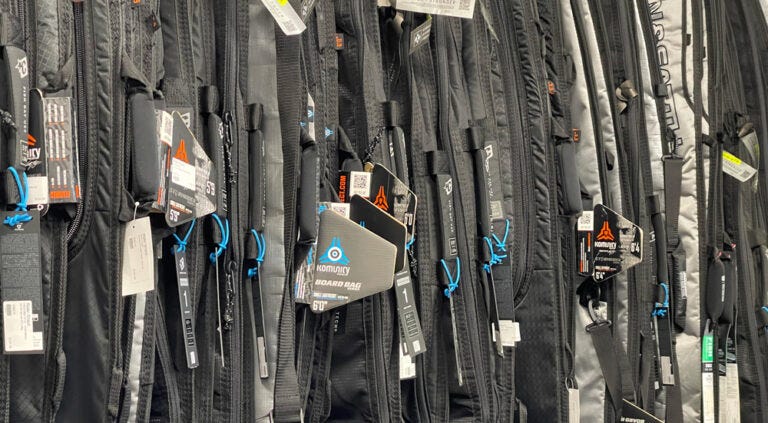 surfboard bags hanging in order
